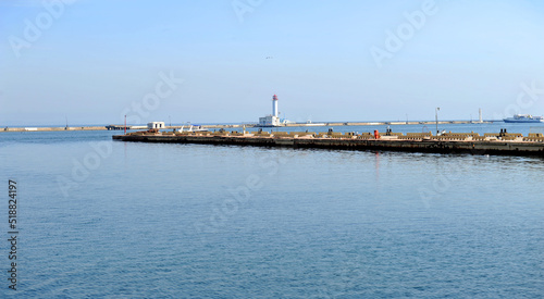 Marine pier, breakwater and lighthouse at sea harbour, Odesa sea