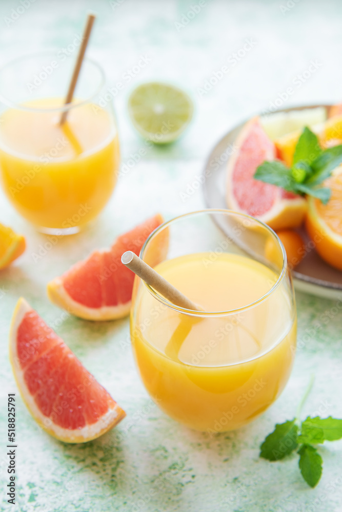 Glass of juice and citrus fruits