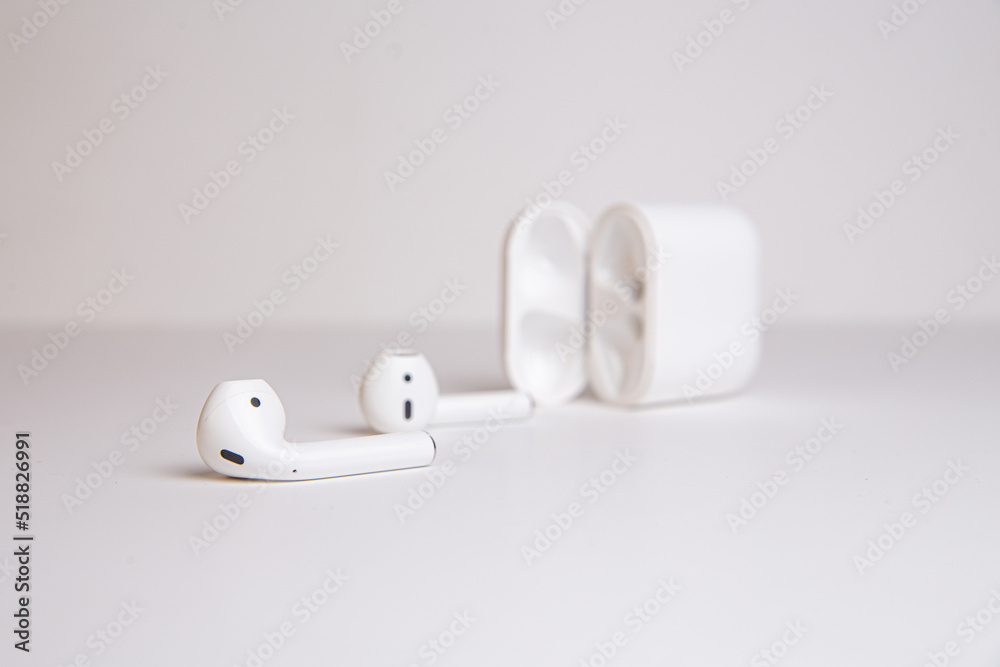 white wireless headphones with a case on a white background white wireless headphones with a case on a white background