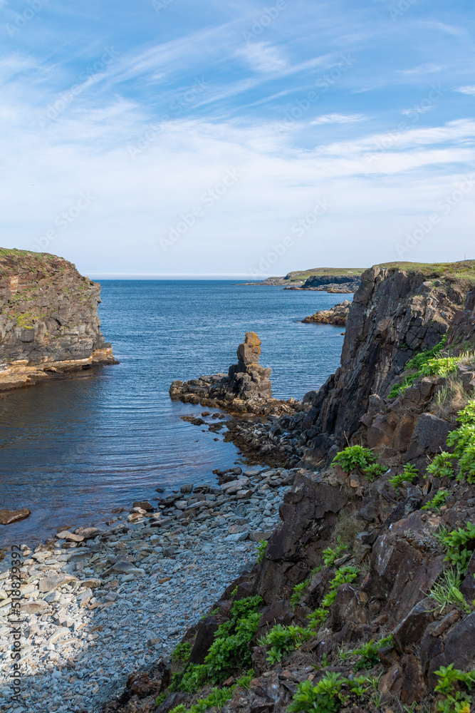 A small gorge at the shore of Elliston in Newfoundland is seen during early sunset.