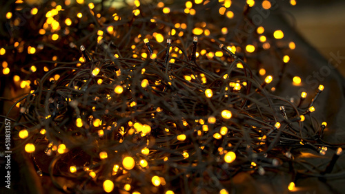 Beautiful garland with lights close up. selective focus of Christmas warm gold garland lights. Christmas lights background