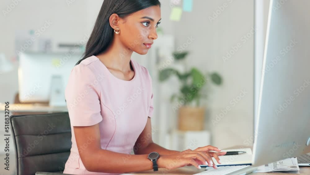 Personal assistant typing a speech for her boss on a computer in an office. A young female secretary writing a document at her workplace. A focused administrator with a deadline working fast