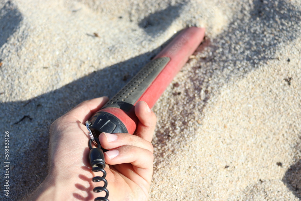 pinpointer in a hand at the beach on the sand Stock Photo Adobe Stock