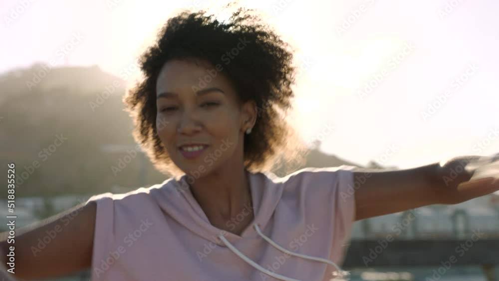 Confident hiphop dancer dancing in the city street at sunset. Handheld portrait of trendy and african modern dancer spinning and popping, having fun and enjoying the evening on urban background Confident hiphop dancer dancing in the city street at sunset. Handheld portrait of trendy and african modern dancer spinning and popping, having fun and enjoying the evening on urban background