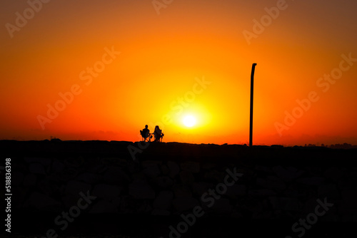 silhouette of a couple in the sunset photo