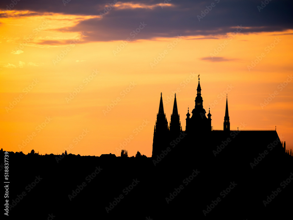 Beautiful landscape at sunset with the silhouette of the Prague Castle guarding the city