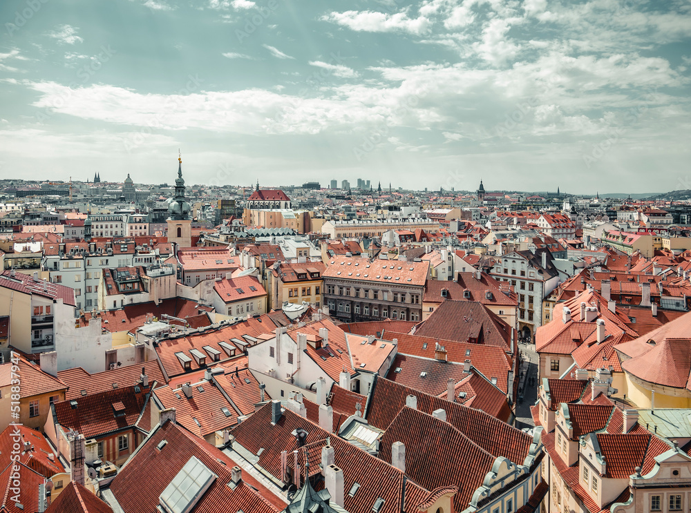 Beautiful aerial view with the city of Prague. Many traditional houses with red roof tiles.