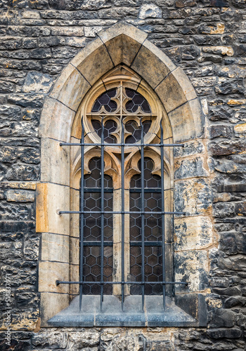 Architectural detail with a window of a church built in gothic medieval style