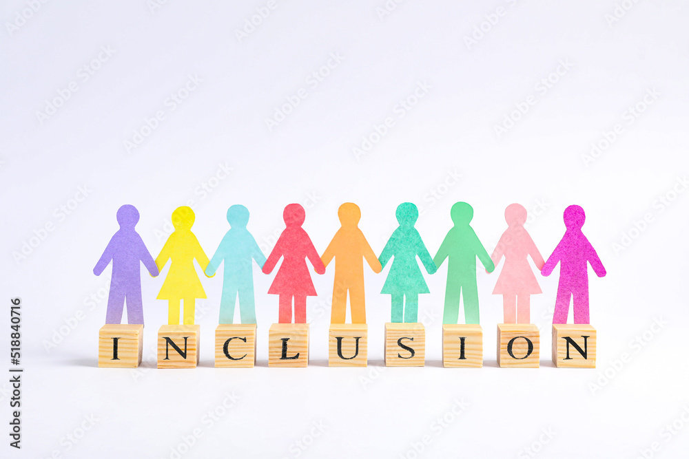 Paper human figures and wooden cubes with word Inclusion on white background Paper human figures and wooden cubes with word Inclusion on white background