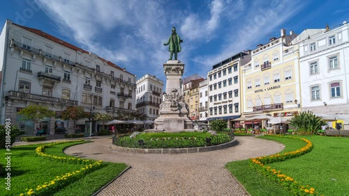 Zoom out time lapse view of the historic Largo da Portagem square on a sunny day in Coimbra, Portugal. 