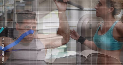 Animation of blue graphs moving against caucasian fit man working out at the gym photo