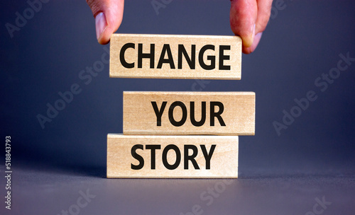 Change your story symbol. Concept words Change your story on wooden blocks on a beautiful grey table grey background. Businessman hand. Business, finacial and change your story concept. Copy space. photo