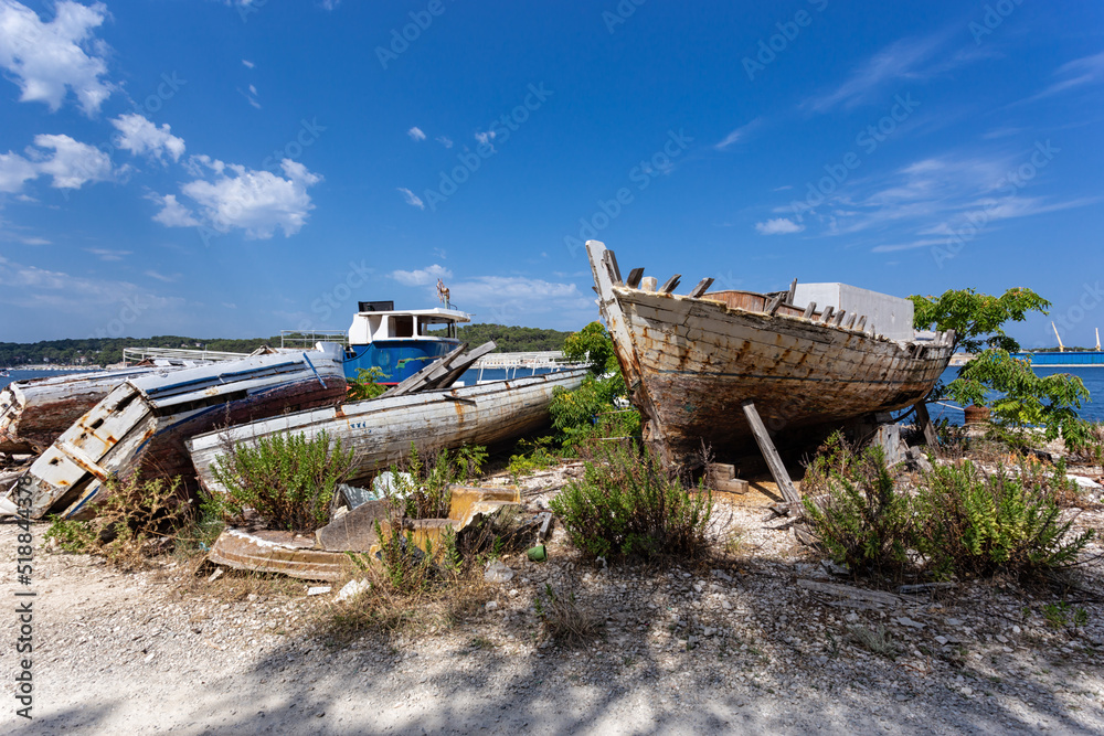 broken boats on the shore, Losinj town, Croatia.