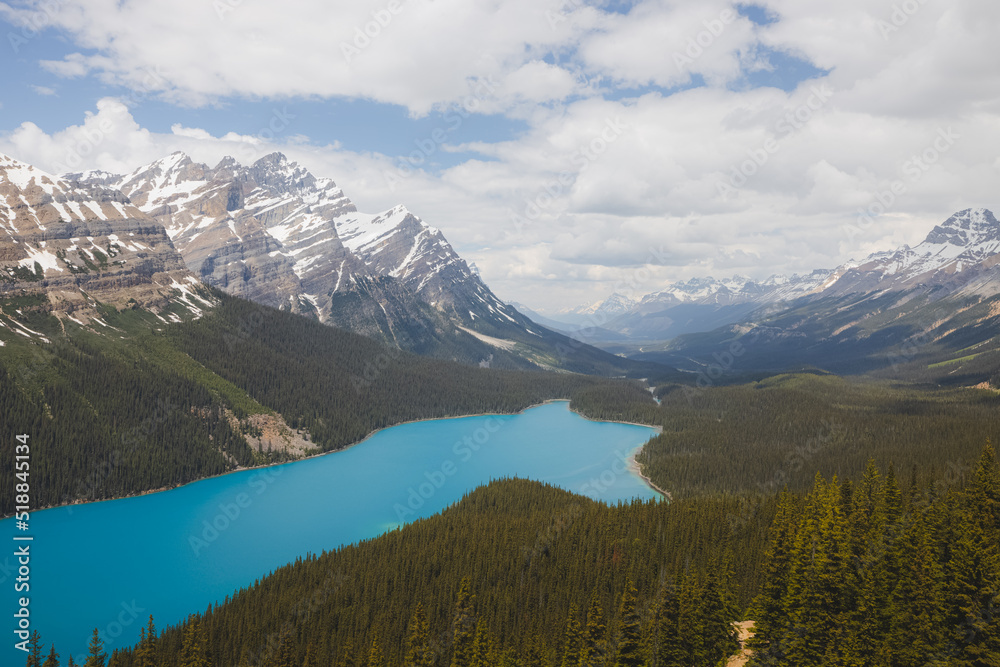 Epic view on a Summer day with emerald blue water and mountain glacier landscape of Peyto Lake in Banff National Park, Alberta, Canada.