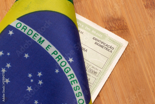 LAURO DE FREITAS, BRASIL - JULY 21, 2022 : brazilian flag next to  brazilian elector's title