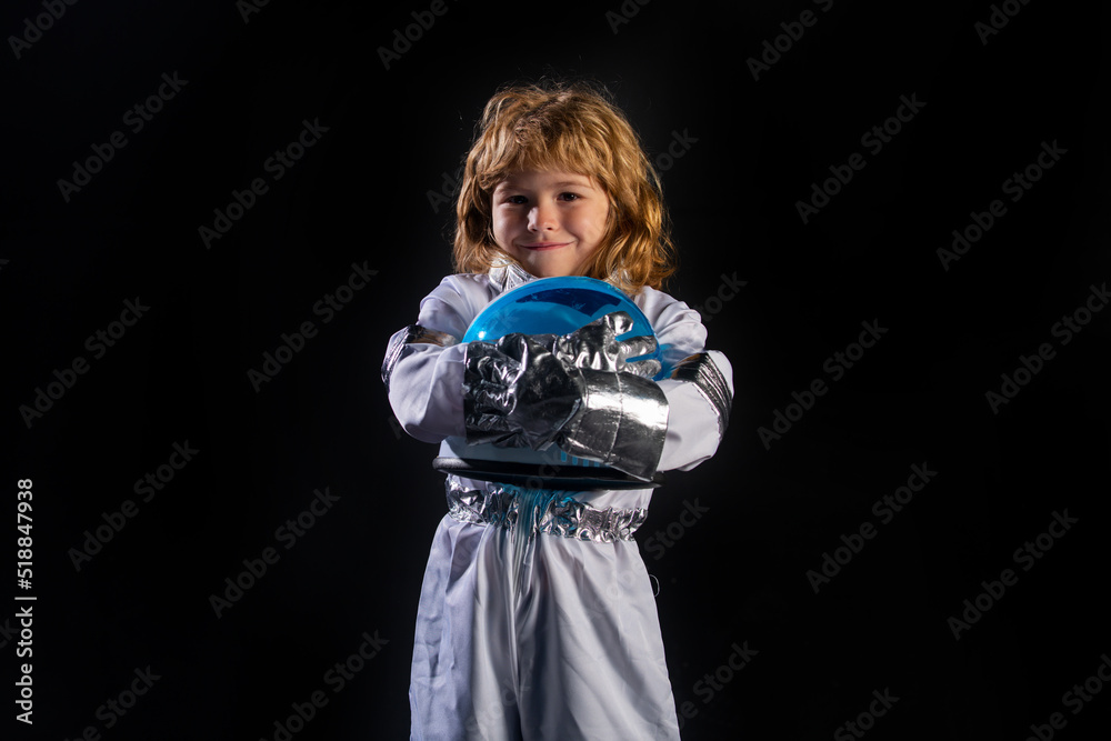 Little boy wearing an astronaut helmet costume and. Cute kid in astronaut playing and dreaming of becoming a spacemen. Little boy wearing an astronaut helmet costume and. Cute kid in astronaut playing and dreaming of becoming a spacemen.