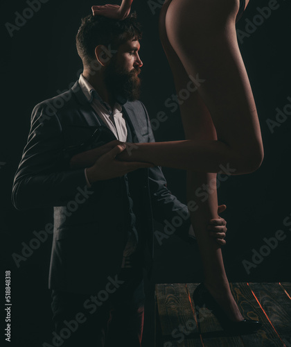 Fetish legs. Fashion portrait of attractive young man with womans sexy legs.