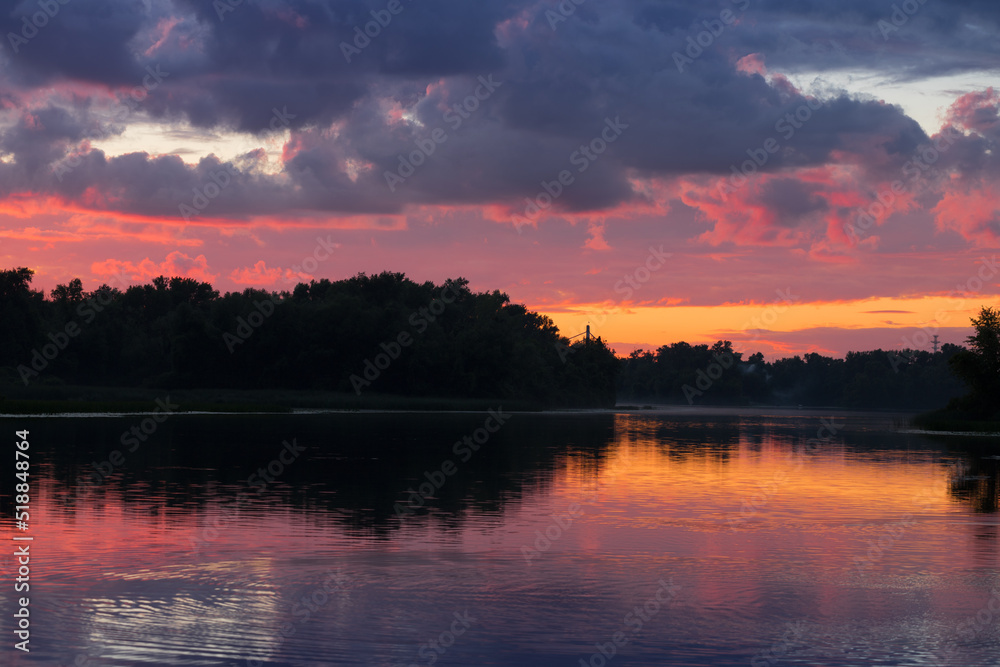 Beautiful cloudy sunset over the Dnipro river in Kyiv