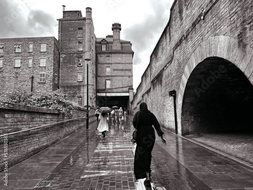 Leaving Foster Square, and walking toward, Cheapside, on a wet day in the centre of, Bradford, Yorkshire, UK          Black and White photo