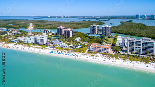 Aerial Drone View in Naples, Florida with the Coast and Sandy Beach in the Foreground on the Gulf of Mexico and Blue Water Bays in the Background Among Mangroves