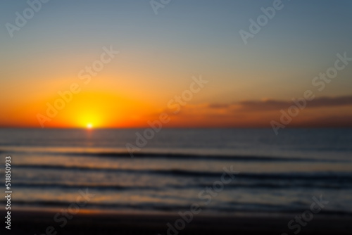 unfocused photo of a beautiful and romantic sunrise at a seashore