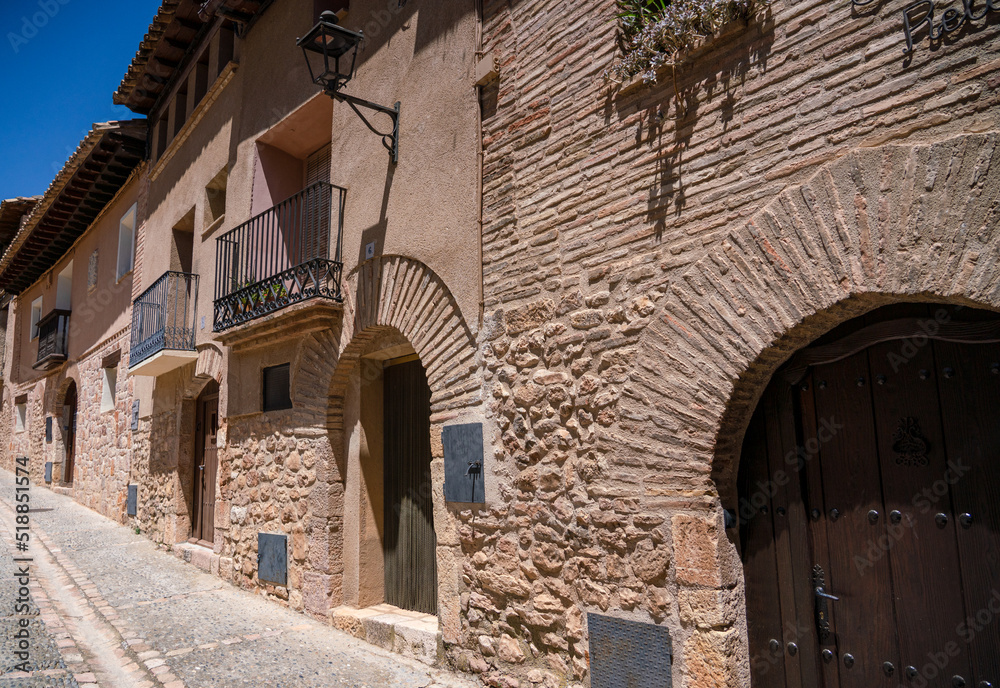 sunshine and shadows along quiet empty alleyways of an ancient medieval village, street view of Alquezar village in Spain
