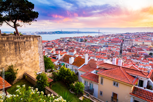 Beautiful panorama of old town Baixa district and Tagus River in Lisbon city during sunset, seen from Sao Jorge Castle hill, Portugal