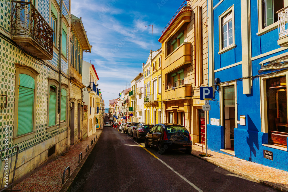 Fototapeta premium Colorful street going down to the Atlantic Ocean in Nazare town, Portugal
