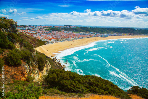 View of Nazare town and the sandy beach seen from high cliff, Portugal