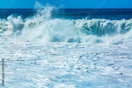 Big blue ocean waves with white foam