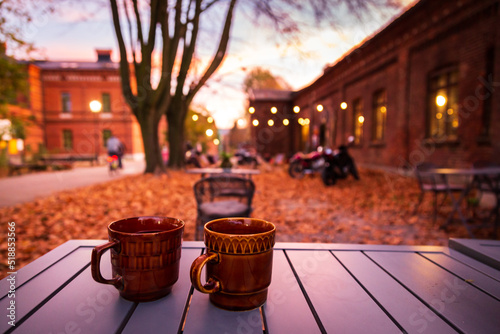 Lodz, Poland: A cup of hot drink on the table in the Ksiezy Mlyn historic distric during .autumn evening