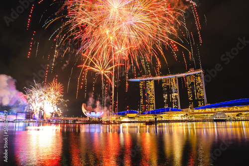 Grand​ Finale Fireworks celebration for Singapore​ National​ Day​ Rehearsal showing tourism in marina bay with a view of city skyscraper at night sky, skyline cityscape with urban light and waterfront