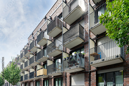 many small balconies with tables, chairs and decoration at a student residence in cologne