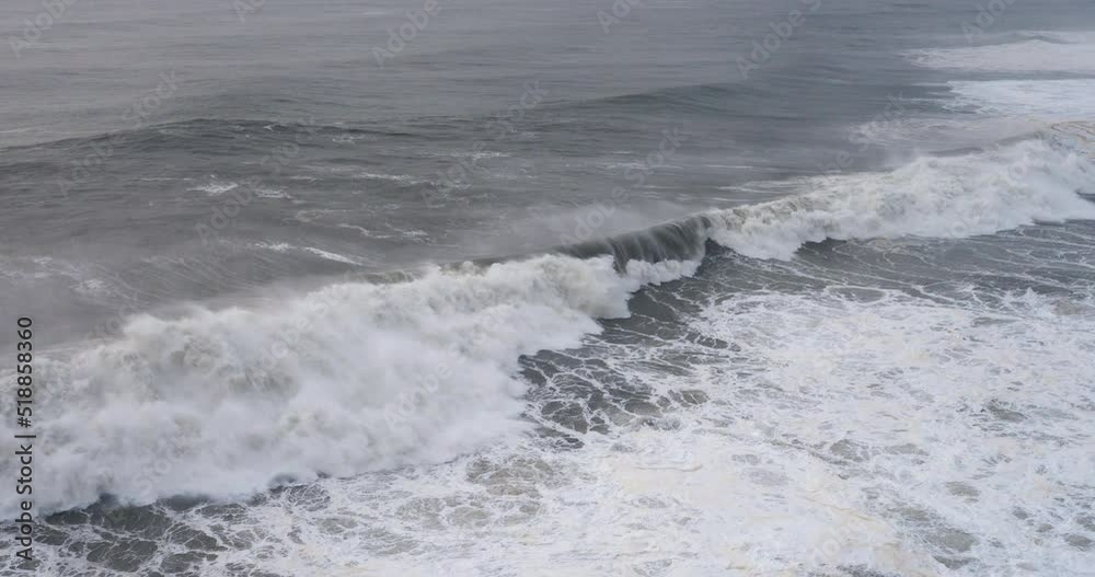 Seascape with big ocean waves crushing against the coast with big splash