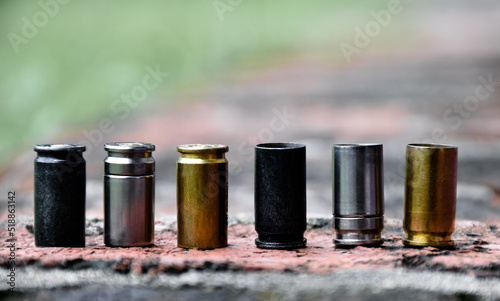 Obraz na plátně Row of 9mm pistol bullet shells on brick floor, soft and selective focus, copy space, concept for searching a key piece of evidence in a murder case at the scene