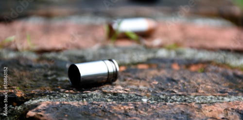 9mm pistol bullet shells on brick floor, soft and selective focus, concept for searching a key piece of evidence in a murder case at the scene.