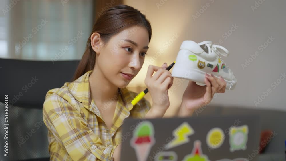 Asian Female Freelancer Working with Inspiration in her Studio. Woman Asian Artist Painting her Own Designs on the Custom Sneaker. People with Fresh Ideas Concept. Asian Female Freelancer Working with Inspiration in her Studio. Woman Asian Artist Painting her Own Designs on the Custom Sneaker. People with Fresh Ideas Concept.