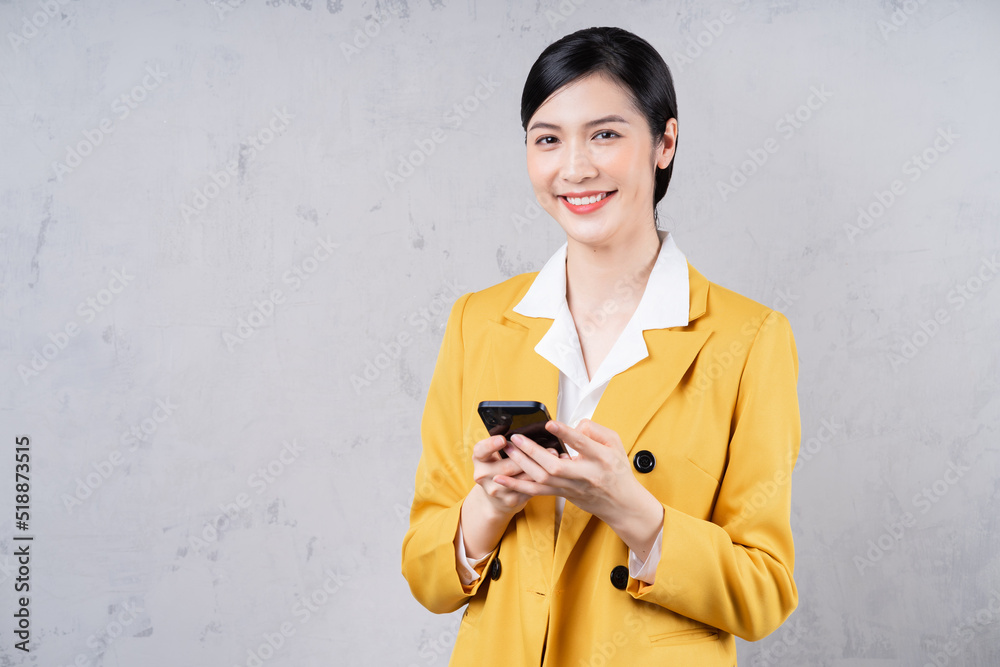 Fototapeta premium Photo of young Asian businesswoman holding phone