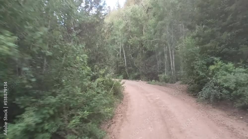 Mountain road sports vehicle POV fast. Nature in natural environment. Recreation, hiking, and fishing ponds. Campground destination and off road jeep, truck and ATV fun.