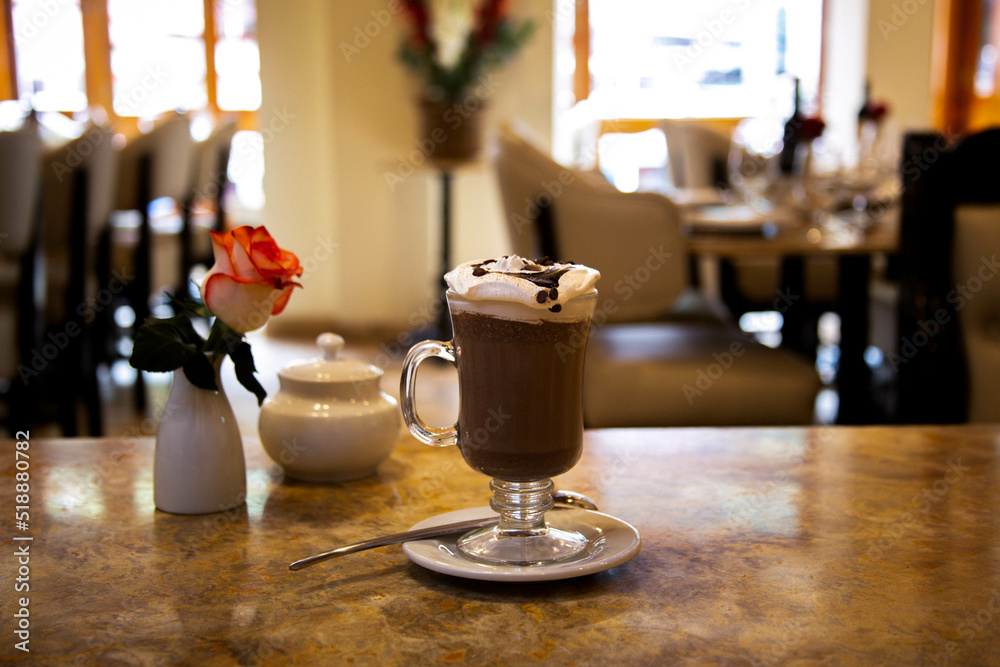 Cappuccino in a glass cup in a restaurant. Cappuccino in a glass cup in a restaurant.