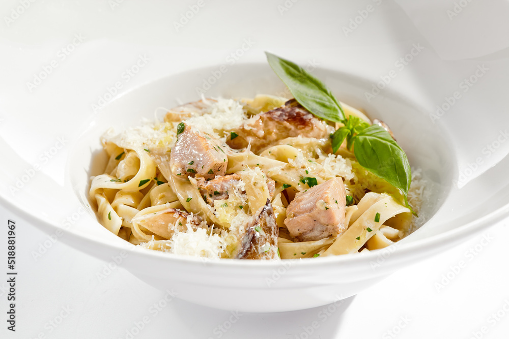 Traditional Italian lunch - pasta fettuccine with chicken and mushrooms with parmesan cheese. Creamy pasta with mushroom and chicken. Chicken and mushroom in cream sauce with homemade pasta.