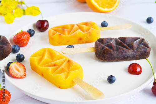 Home made ice cream with berries, orange, Summer food Top view