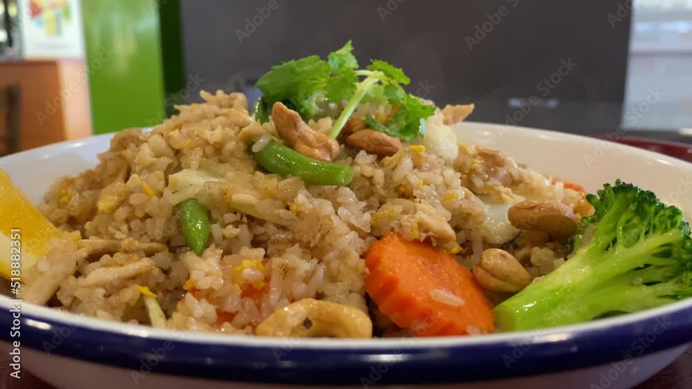 Steaming nasi goreng served with chicken is a southeast asian dish Steaming nasi goreng served with chicken is a southeast asian dish