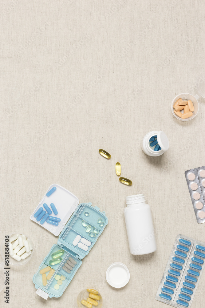 Pill box daily taking medicine, with tablets and capsules. Drugs, medication as alternative medicine for treatment and good health. Medicine dose box with pills on table, flat lay background Pill box daily taking medicine, with tablets and capsules. Drugs, medication as alternative medicine for treatment and good health. Medicine dose box with pills on table, flat lay background