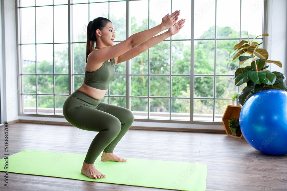 young asian woman working out and doing yoga at home, healthy concept. young asian woman working out and doing yoga at home, healthy concept.
