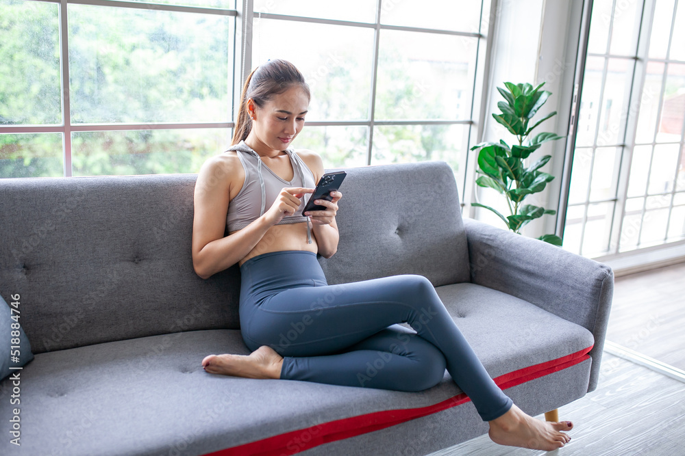 Young Asian woman using smratphone at home, feel relax and enjoy communicate and discuss in living room. Young Asian woman using smratphone at home, feel relax and enjoy communicate and discuss in living room.