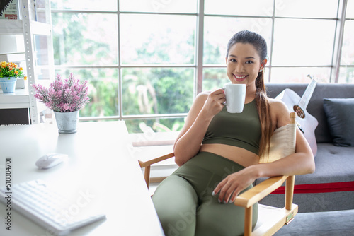 Young Asian woman using laptop computer checking social media application on website online with coffee at home, feel relax and enjoy communicate and discuss in living room. Free Download Young Asian woman using laptop computer checking social media application on website online with coffee at home, feel relax and enjoy communicate and discuss in living room. - GFXLoad