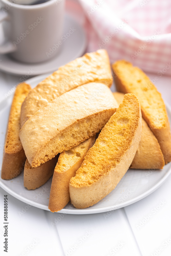 Sweet anicini cookies on plate. Italian biscotti with anise flavor on white table.