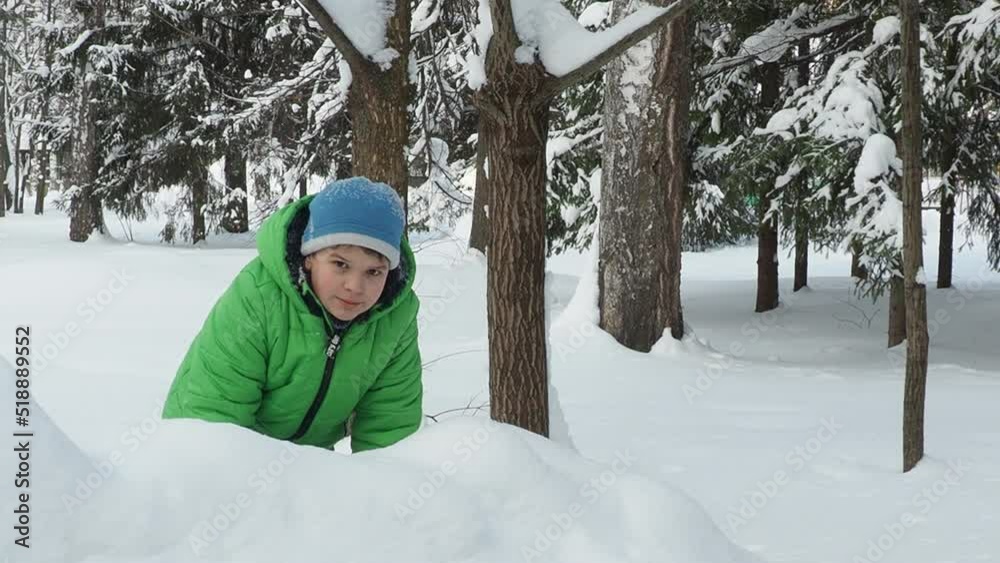 A family with children walks in the winter in the forest. Boy and girl on a walk in the forest or park. play, throw snowballs, wallow in the snow, snow angel. Holidays for Christmas, New Year. A family with children walks in the winter in the forest. Boy and girl on a walk in the forest or park. play, throw snowballs, wallow in the snow, snow angel. Holidays for Christmas, New Year.