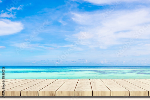 Top of wood balcony table with seascape and palm leaves, sea and sky at beach